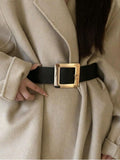 Beige coat with a black belt and gold buckle