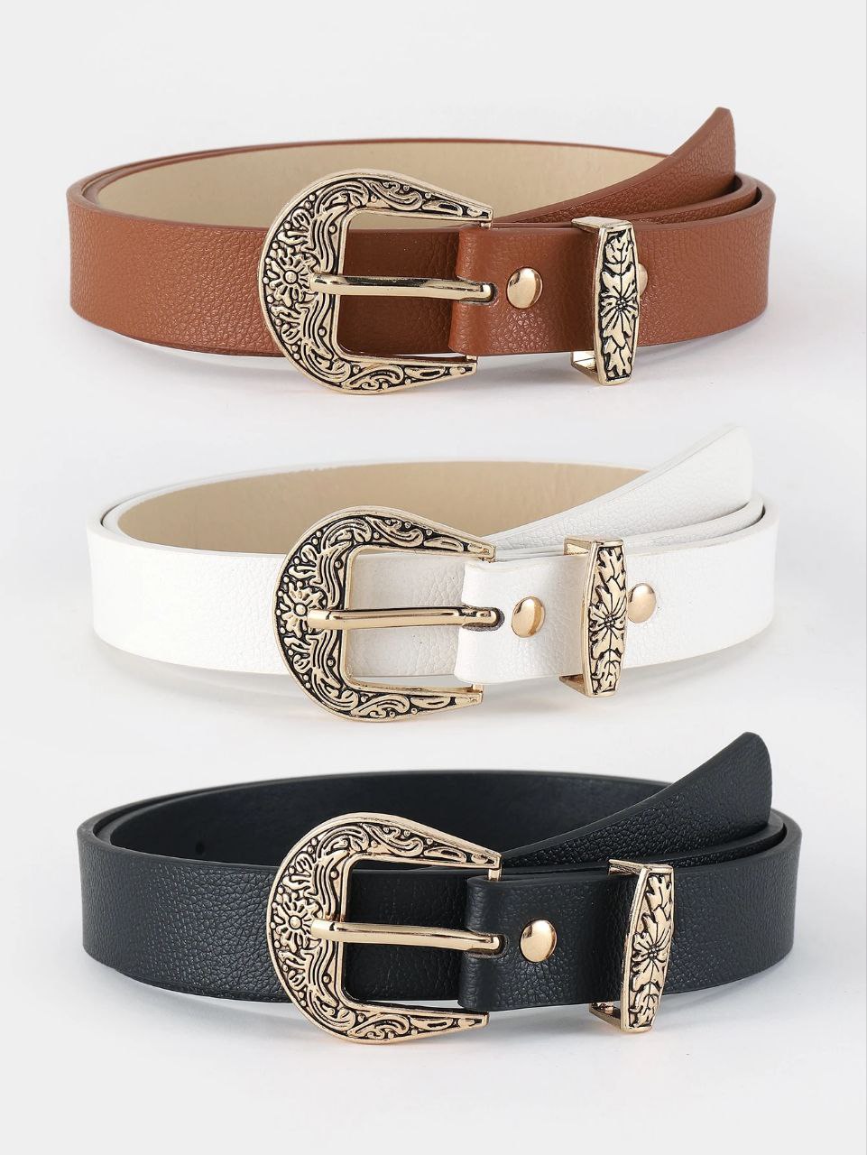 Three belts in brown, white, and black with gold buckles on a light gray background