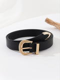 Black belt with a gold buckle on a white background