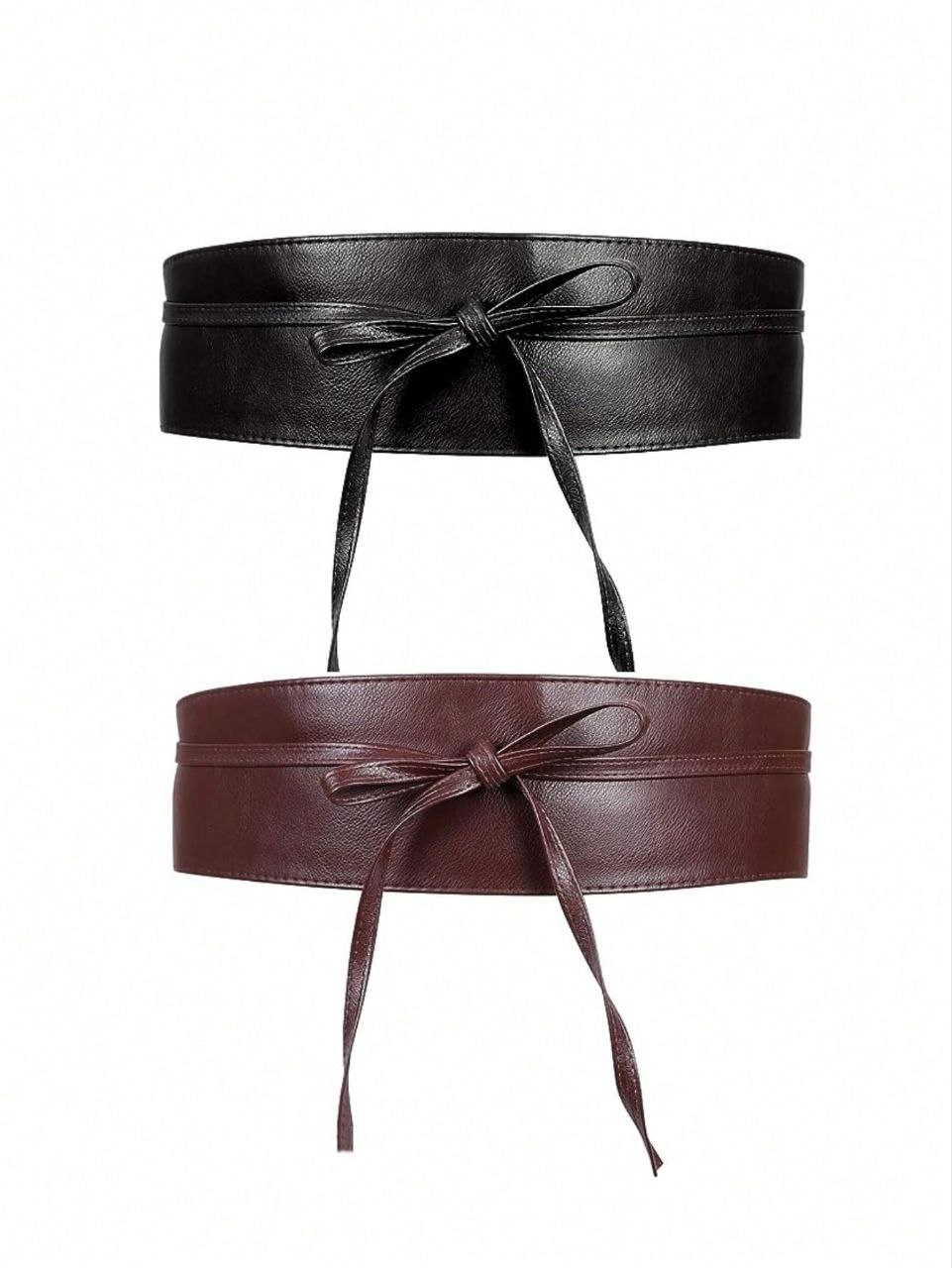 Two leather belts with bows on a white background