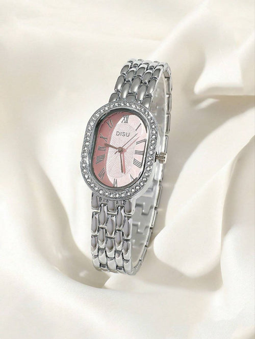 Silver watch with pink face on a white fabric background