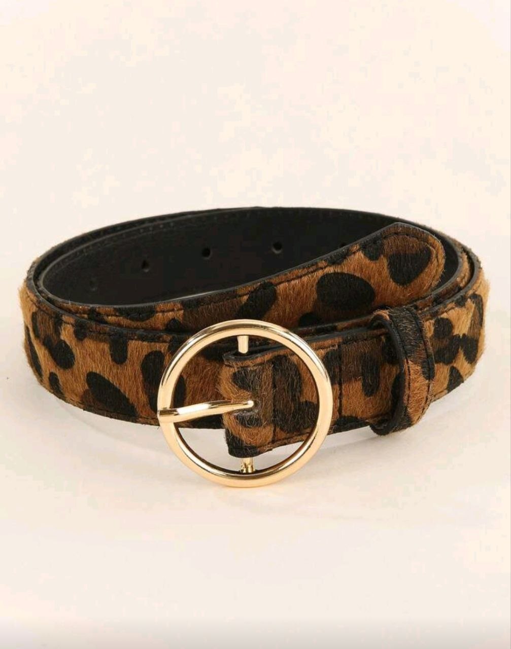 Leopard print belt with a gold buckle on a white background